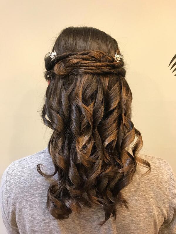 Prom hair styling with curls and flower pins